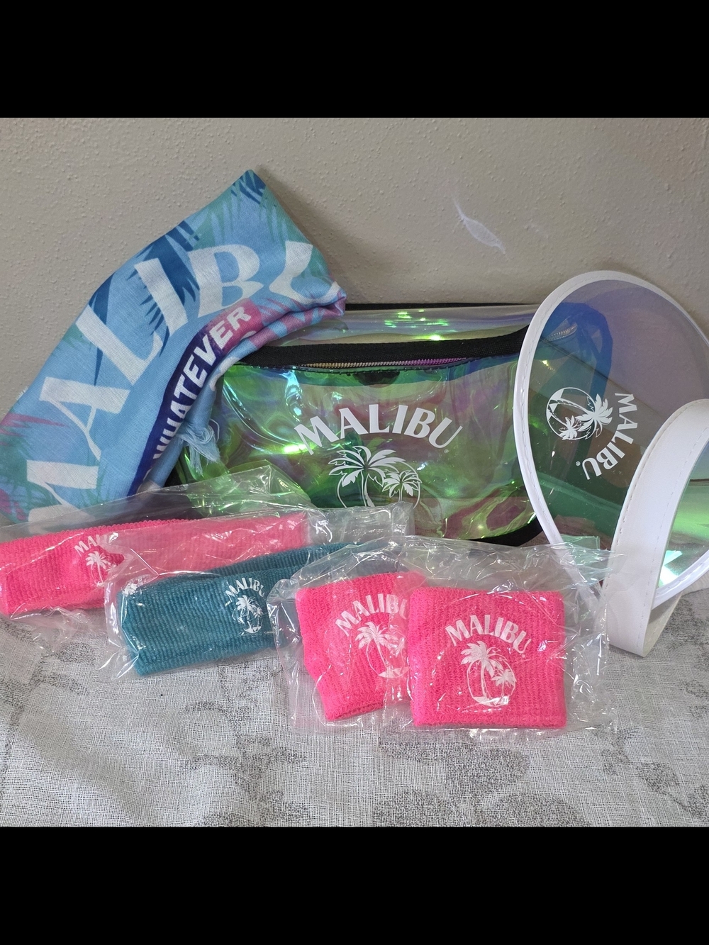 Malibu iridescent clear fanny pack with teal, pink, and aqua accessories
